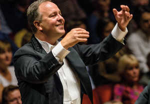 Färgbild på dirigenten Sakari Oramo på podiet. Fotografi.