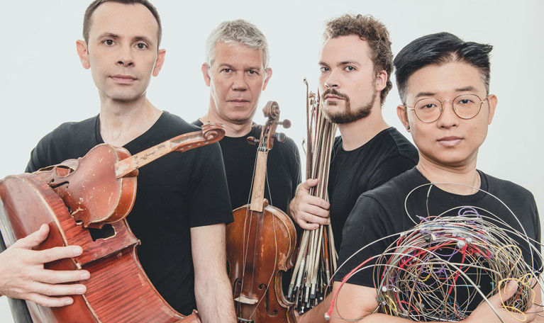 Man som sitter på en pianopall. Fotografi.