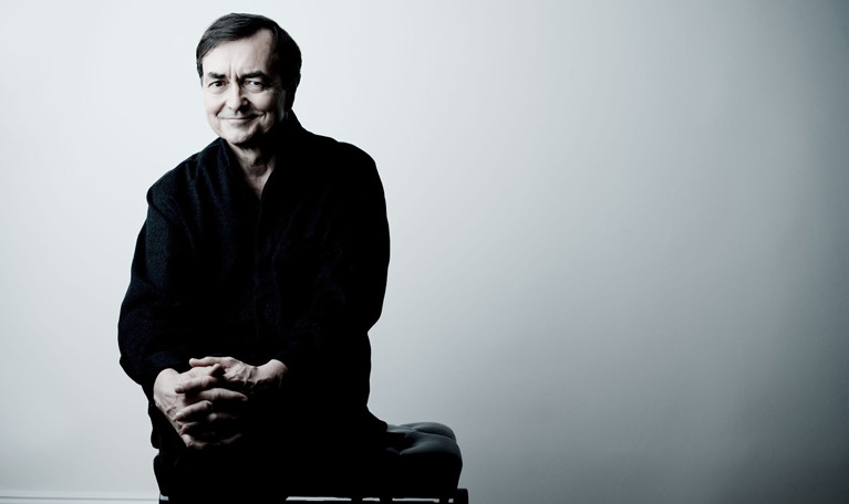 Man som sitter på en pianopall. Fotografi.